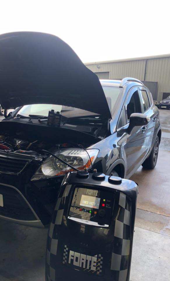 Forté Power Clean machine connected to a car in the PLA workshop